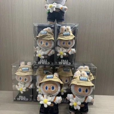 Six boxed plush figures in straw hats, stacked in clear display boxes on a pale table