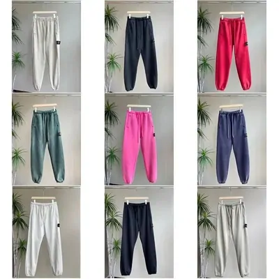 Eight pairs of joggers on open shelving in white, navy, pink, green and grey